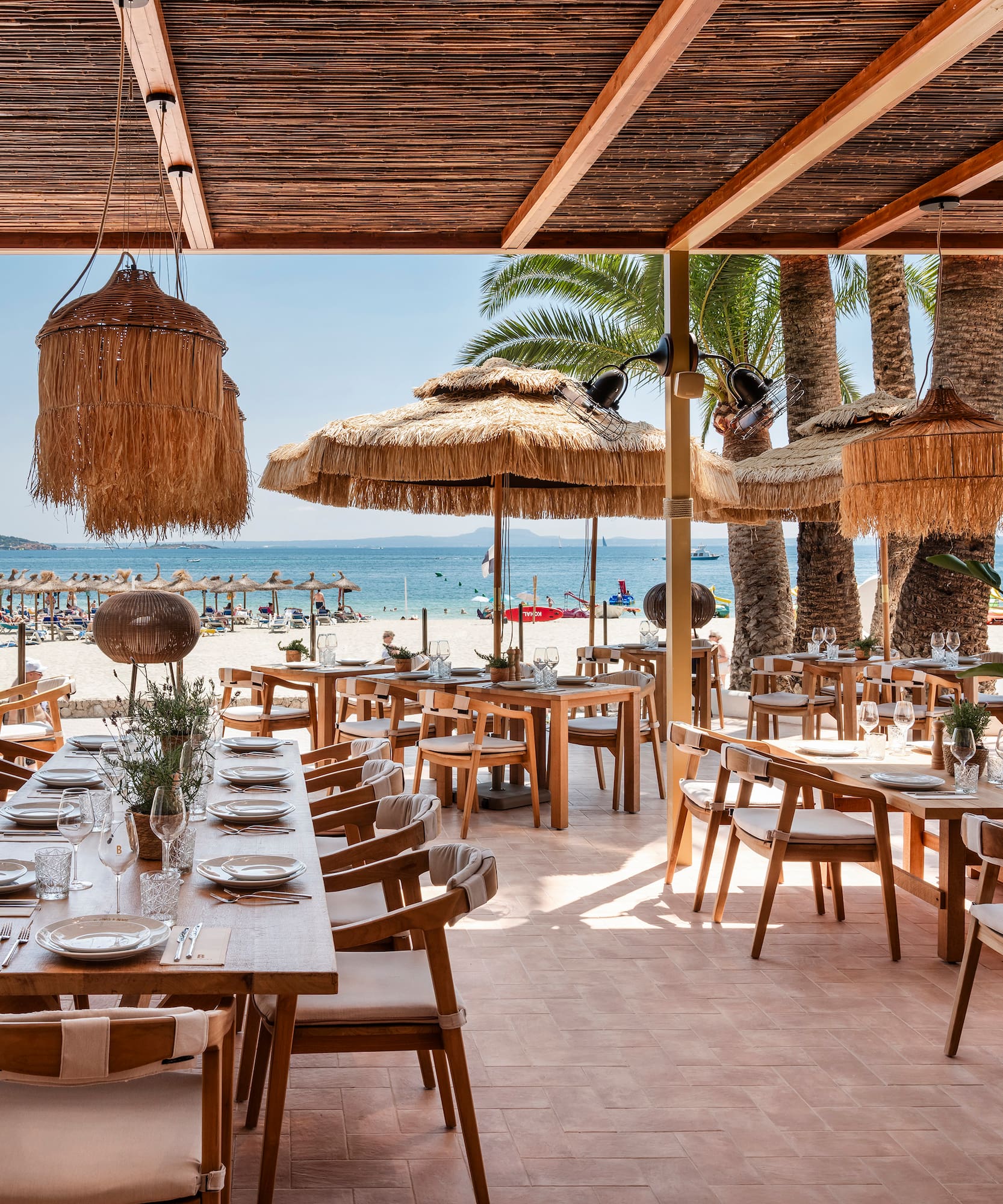 a restaurant with tables and chairs on a beach