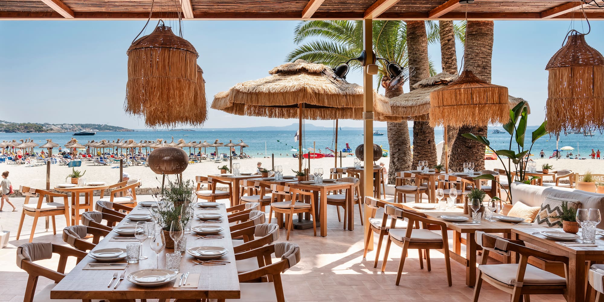 a restaurant with tables and chairs on a beach