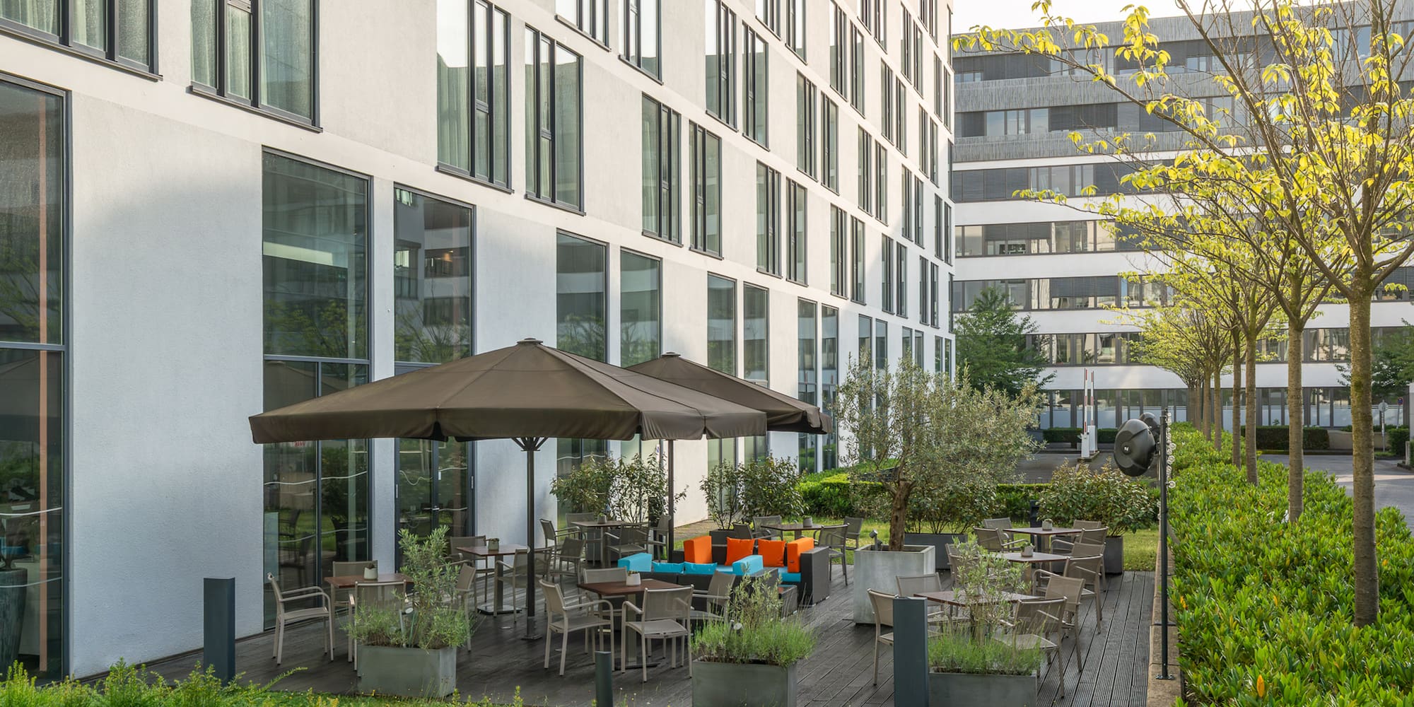 a building with a patio area and umbrellas