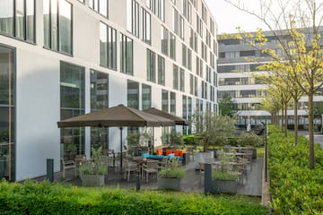 a building with a patio area and umbrellas