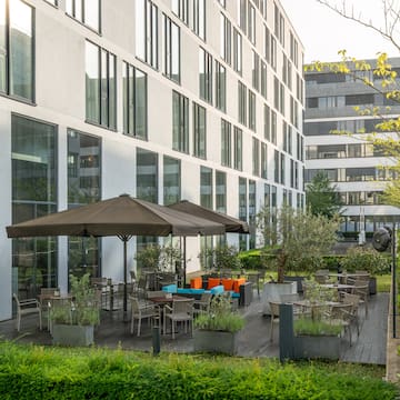 a building with a patio area and umbrellas