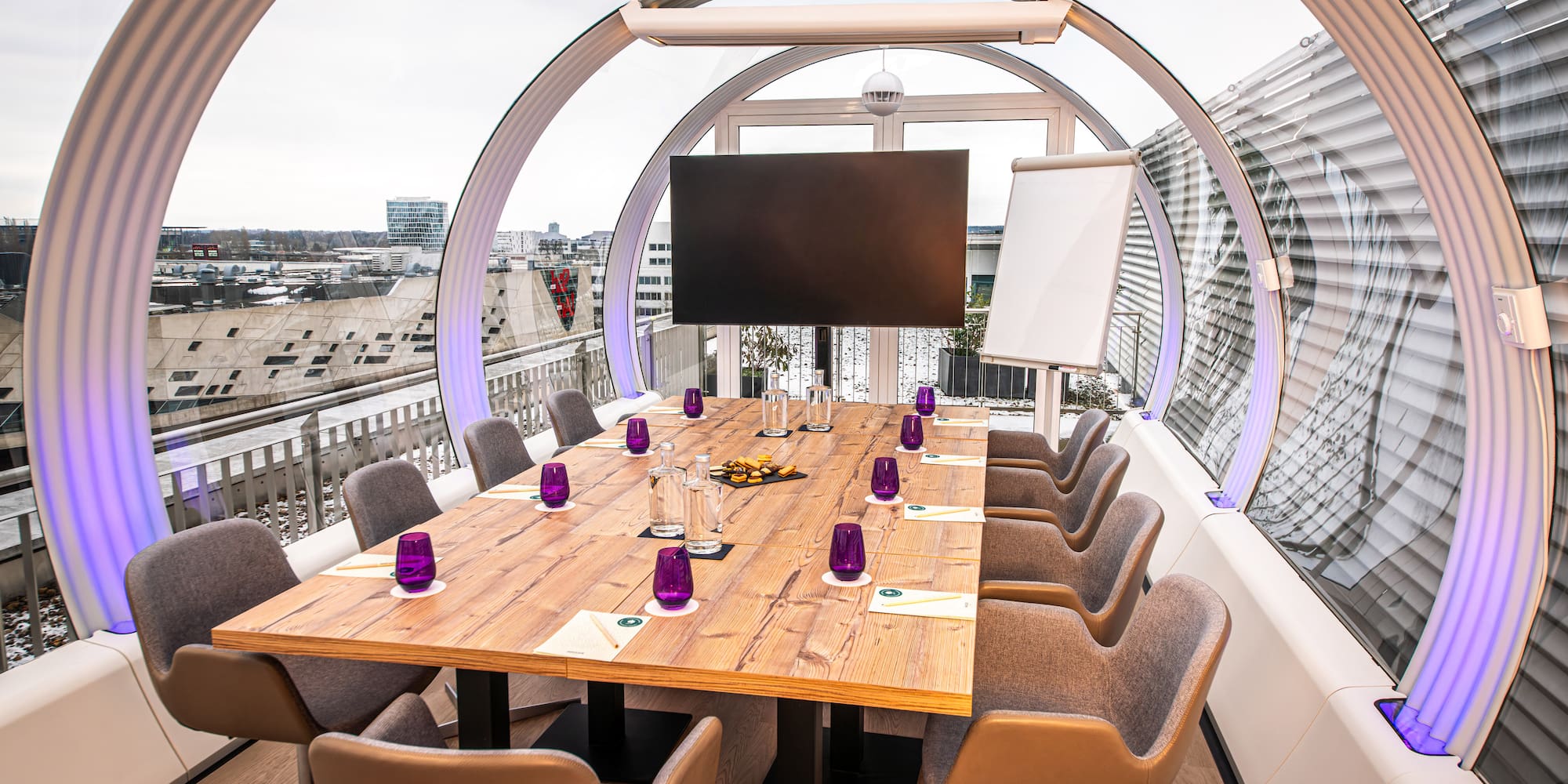 a table with purple glasses and a television on it