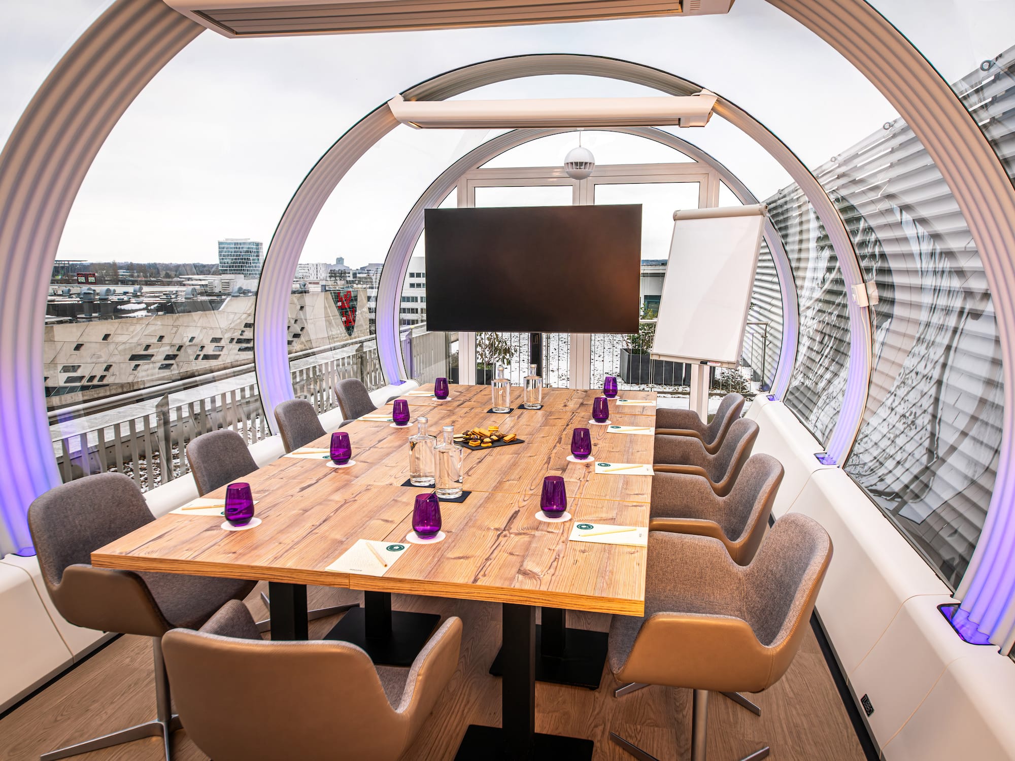 a table with purple glasses and a television on it