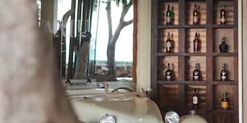 a car parked in a room with bottles on the shelves