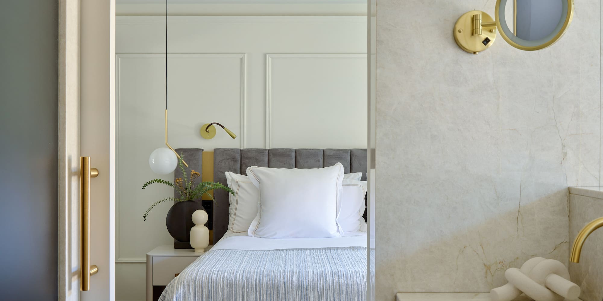 a bed with pillows and a lamp