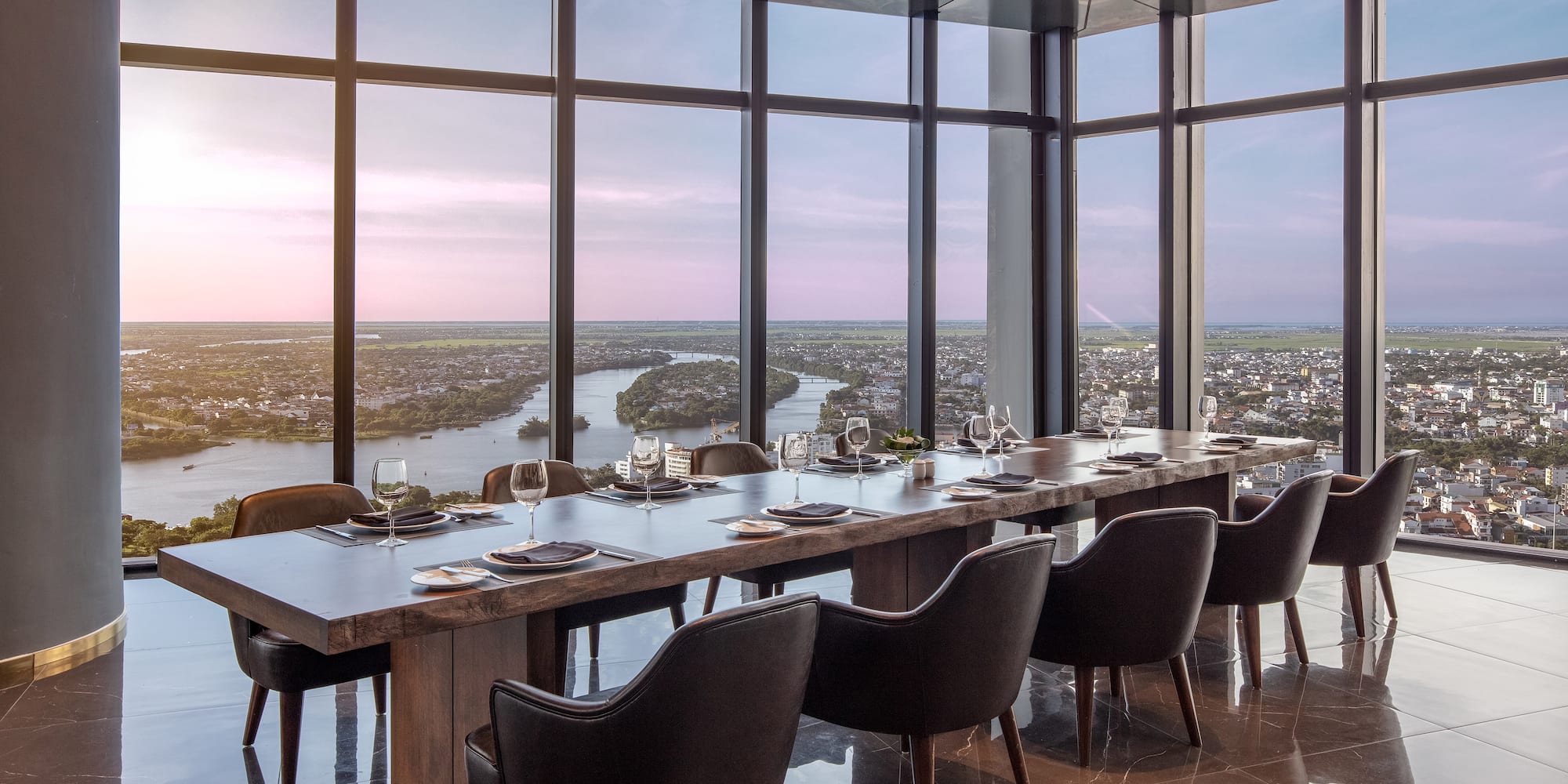 a large table with chairs and a view of a city