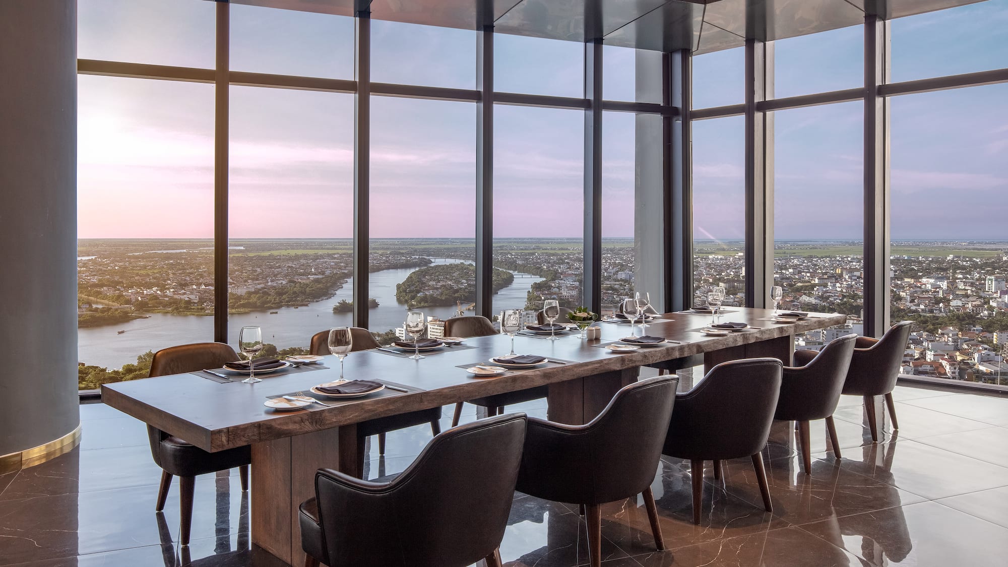 a large table with chairs and a view of a city