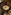 Light yellow cocktail with dried lime in coupe glass on rustic wooden table.