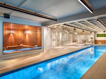 a indoor swimming pool with a large glass wall