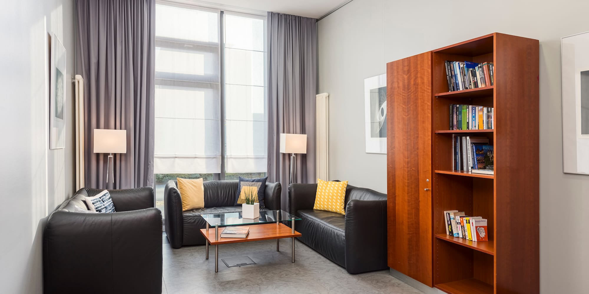 a room with couches and a bookcase