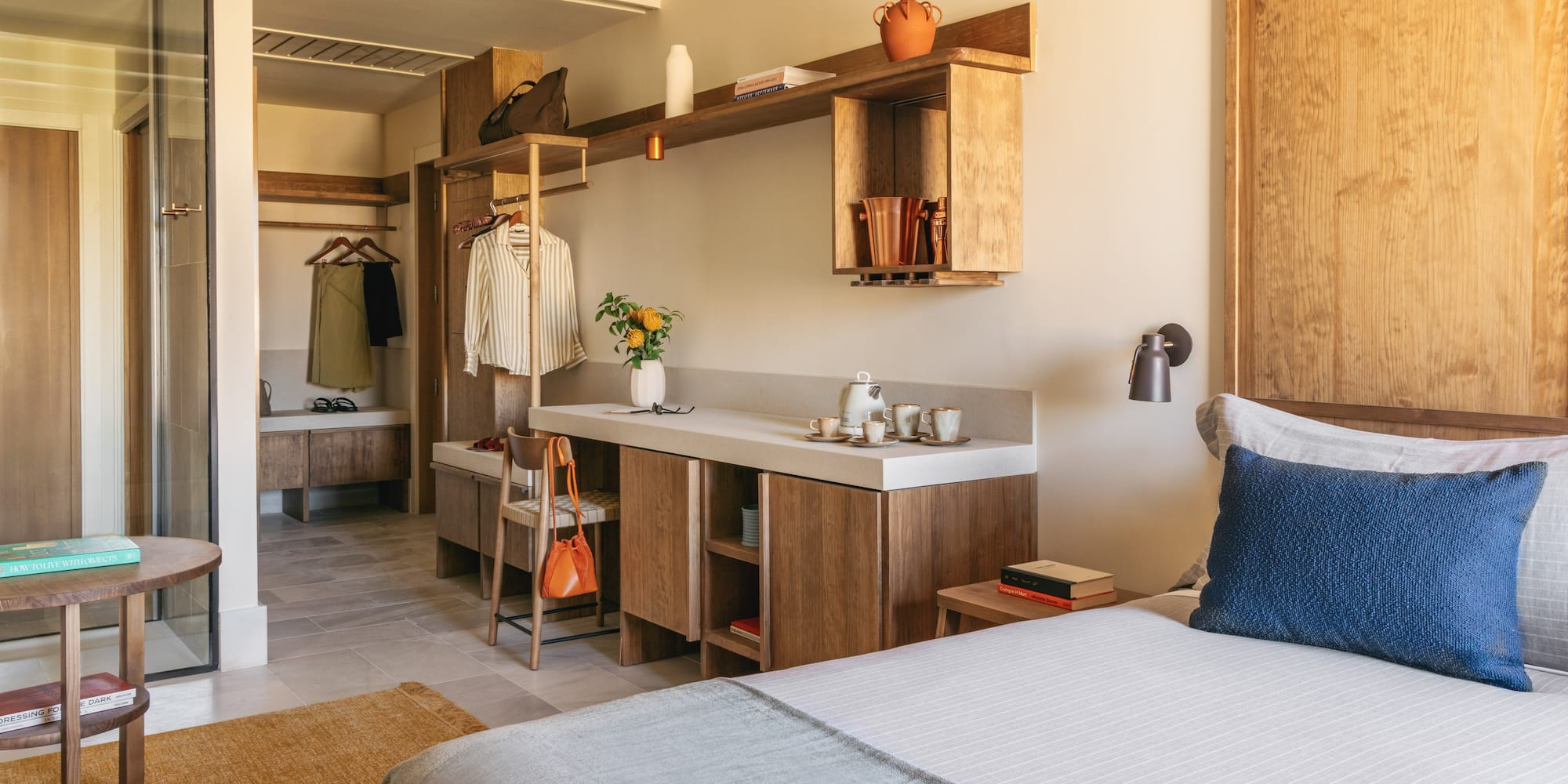 a bedroom with a bed and a sink and shelves