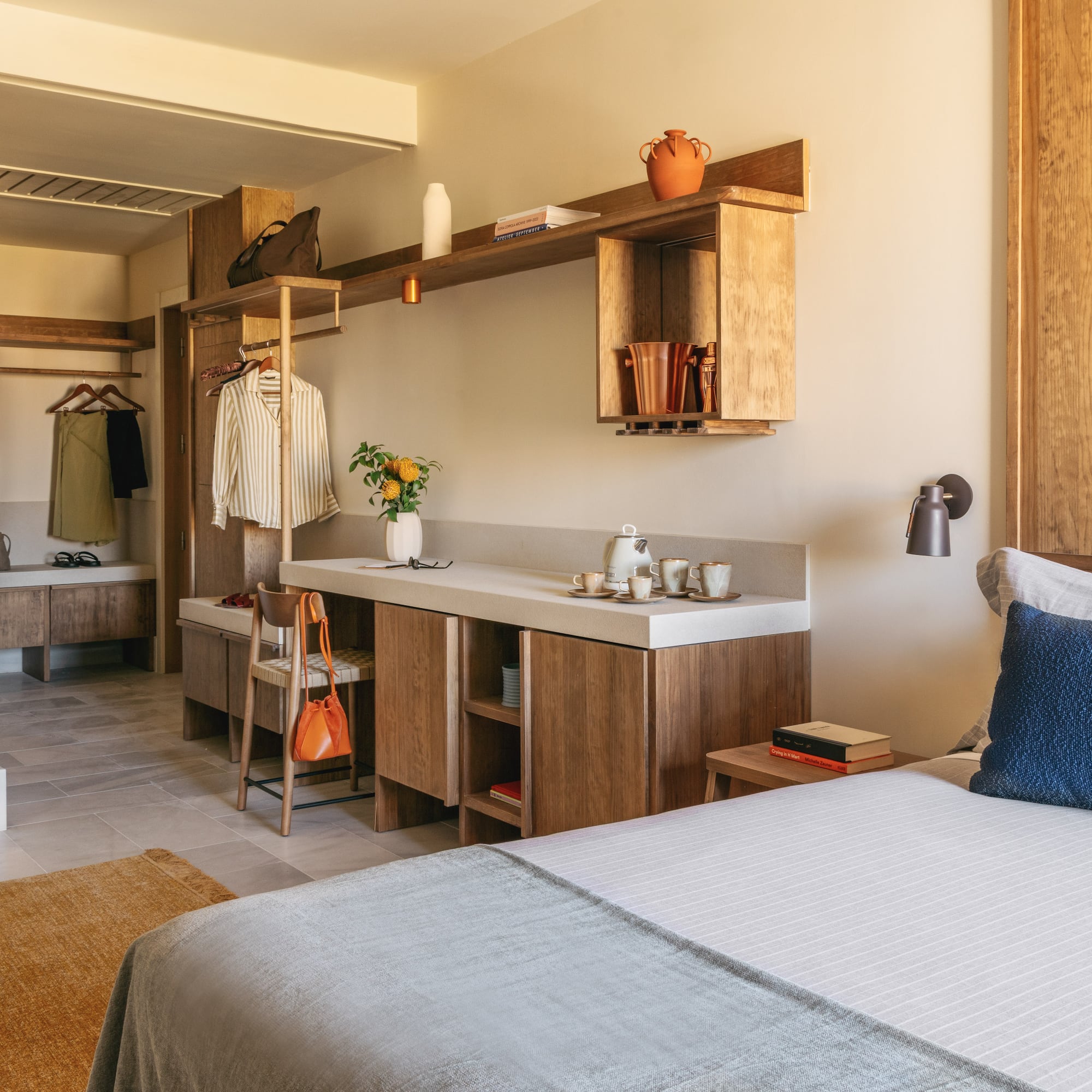 a bedroom with a bed and a sink and shelves