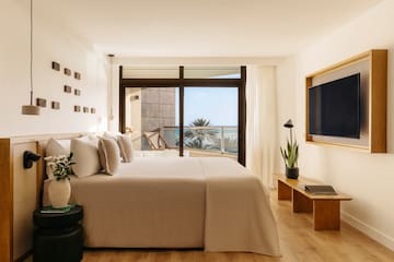 a bedroom with a television and a bed