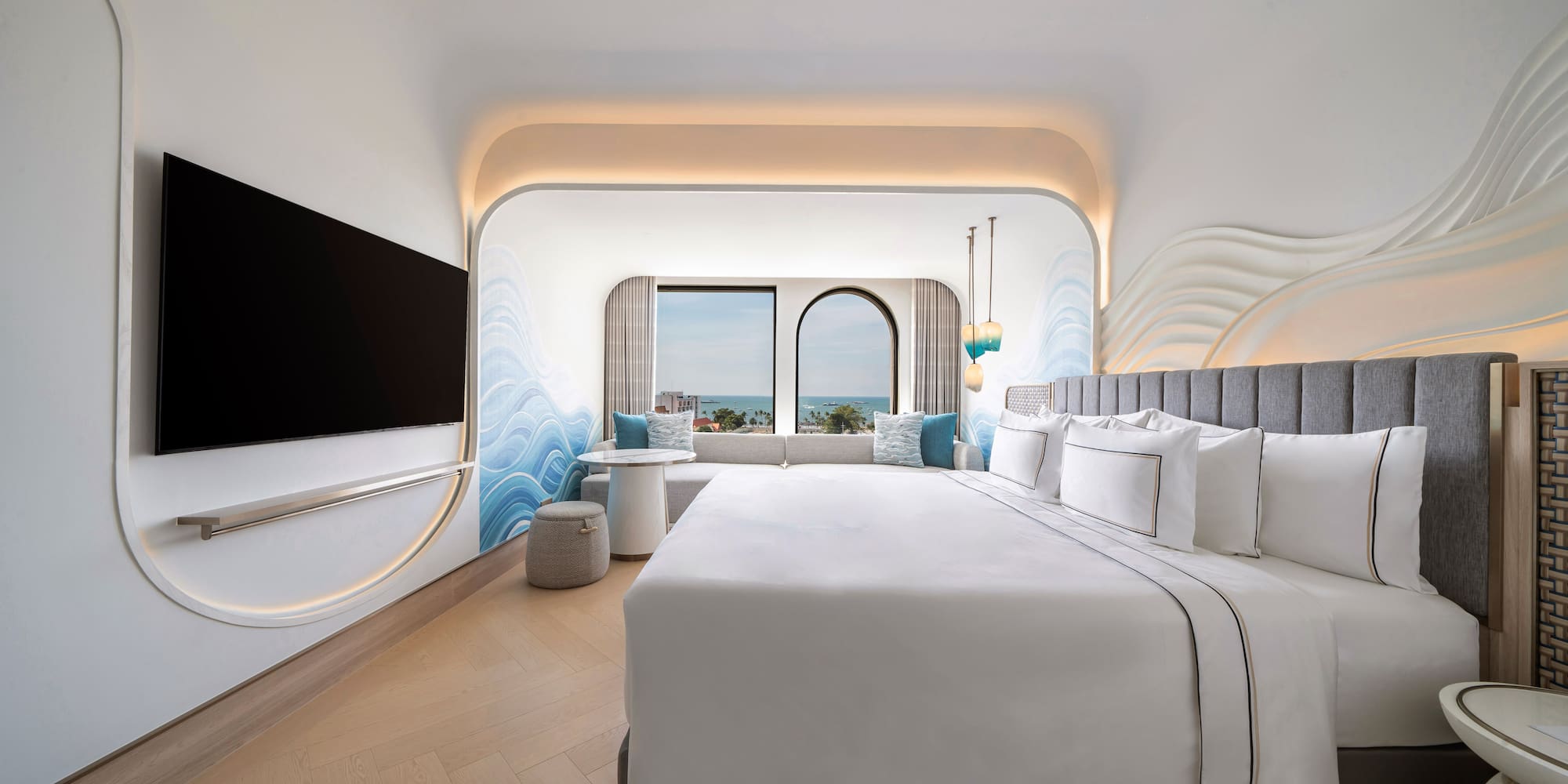 a room with a bed and a television