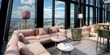 a room with a couch and tables and chairs
