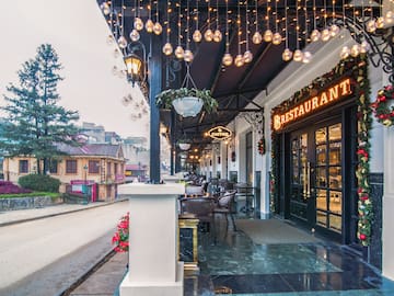 a restaurant with lights from the ceiling