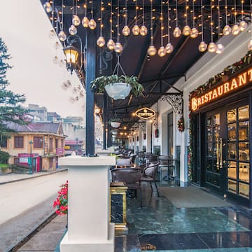 a restaurant with lights from the ceiling