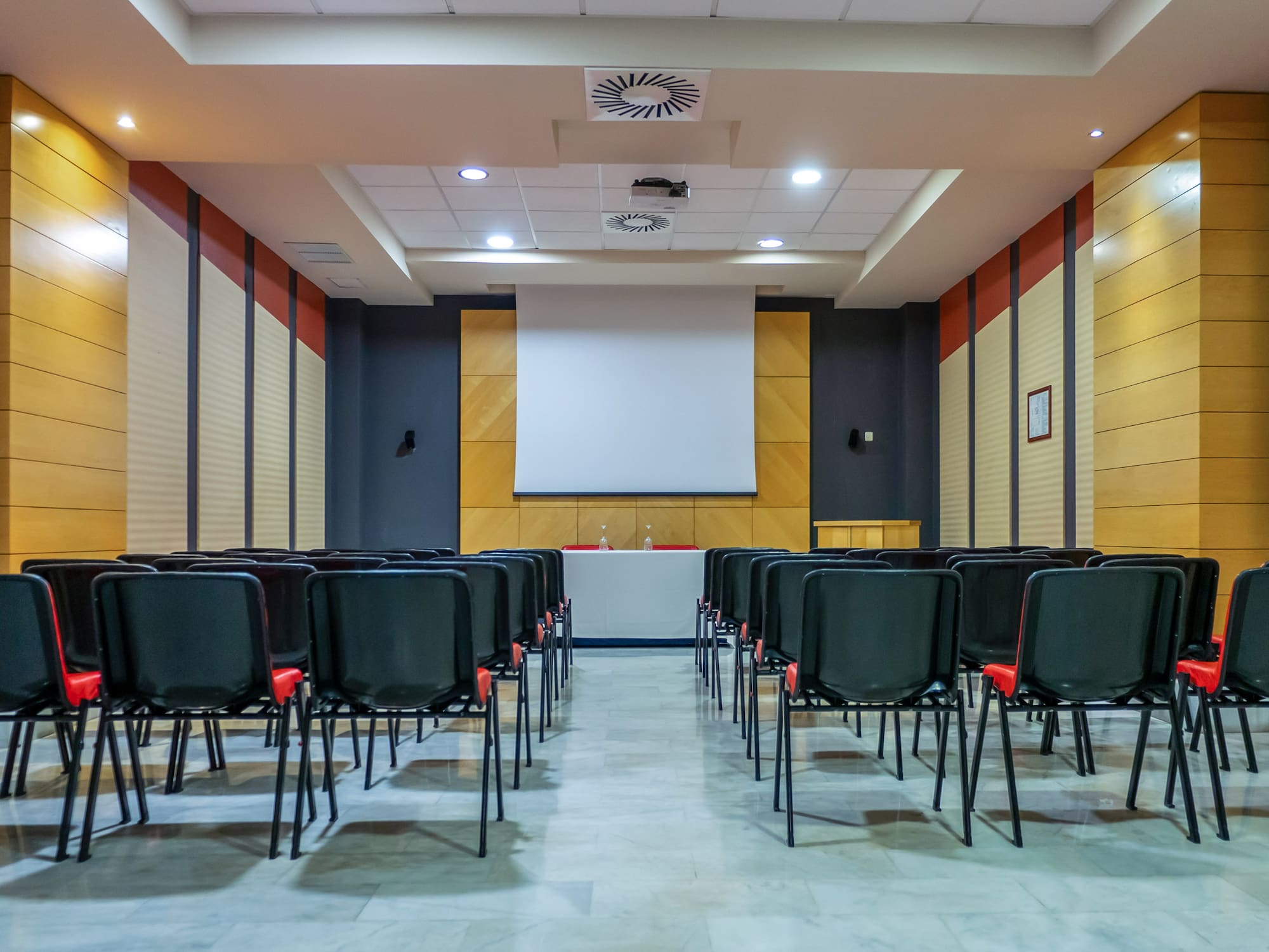 a room with chairs and a projector screen