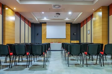 a room with chairs and a projector screen