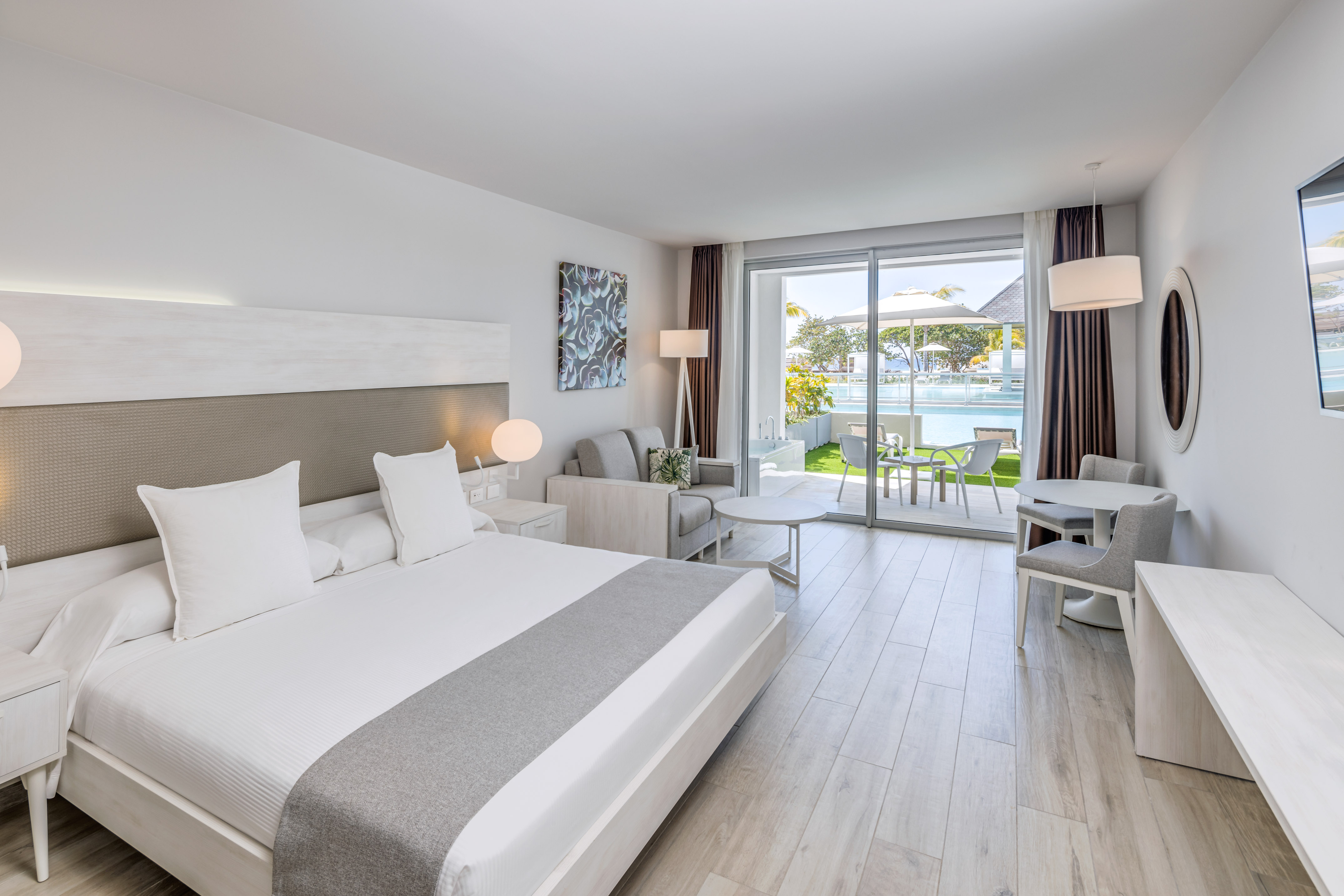 a room with a bed and a table and chairs