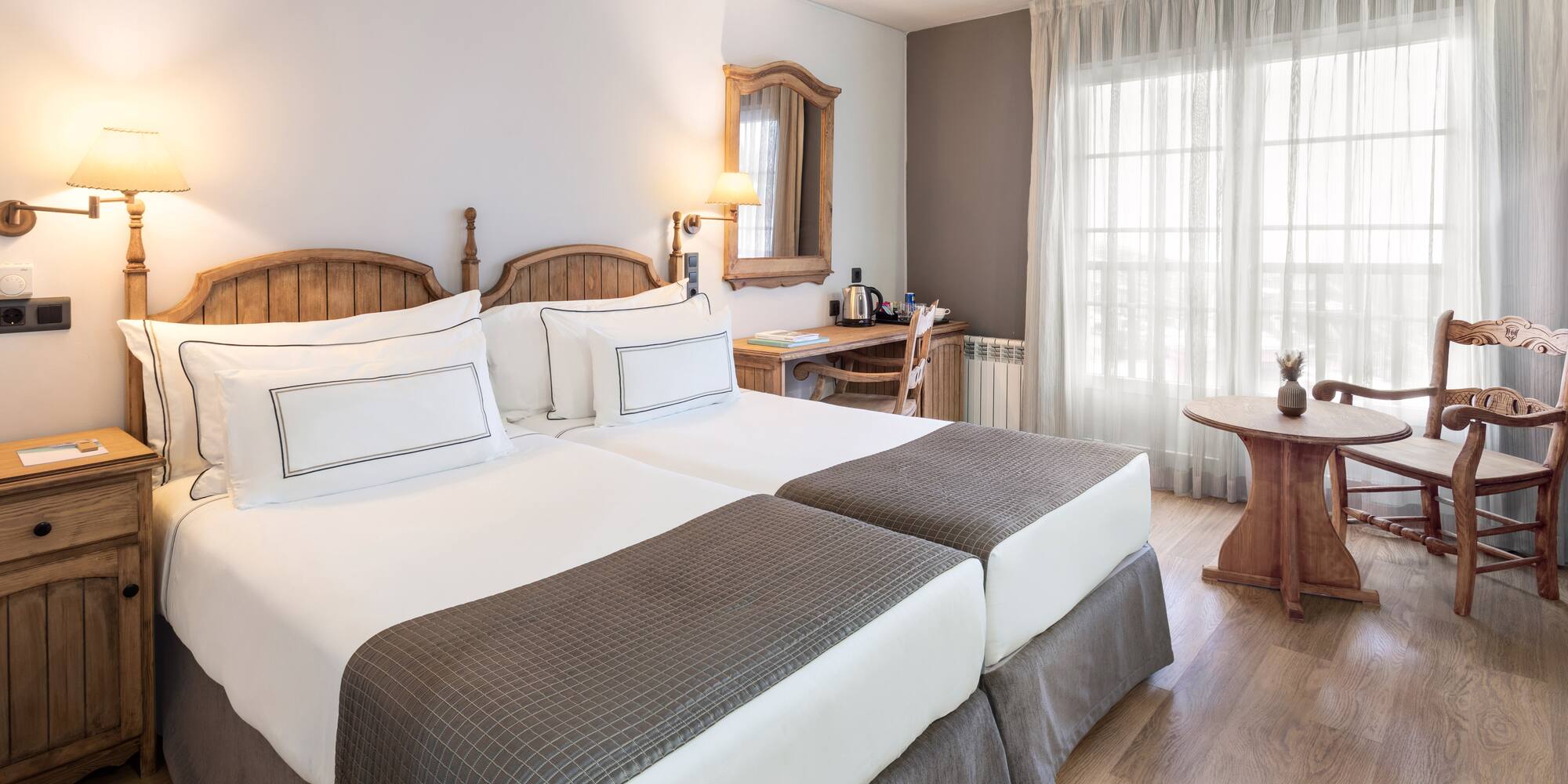 a room with two beds and a table