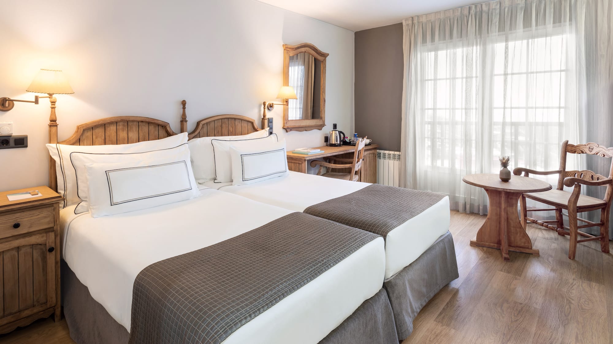 a room with two beds and a table