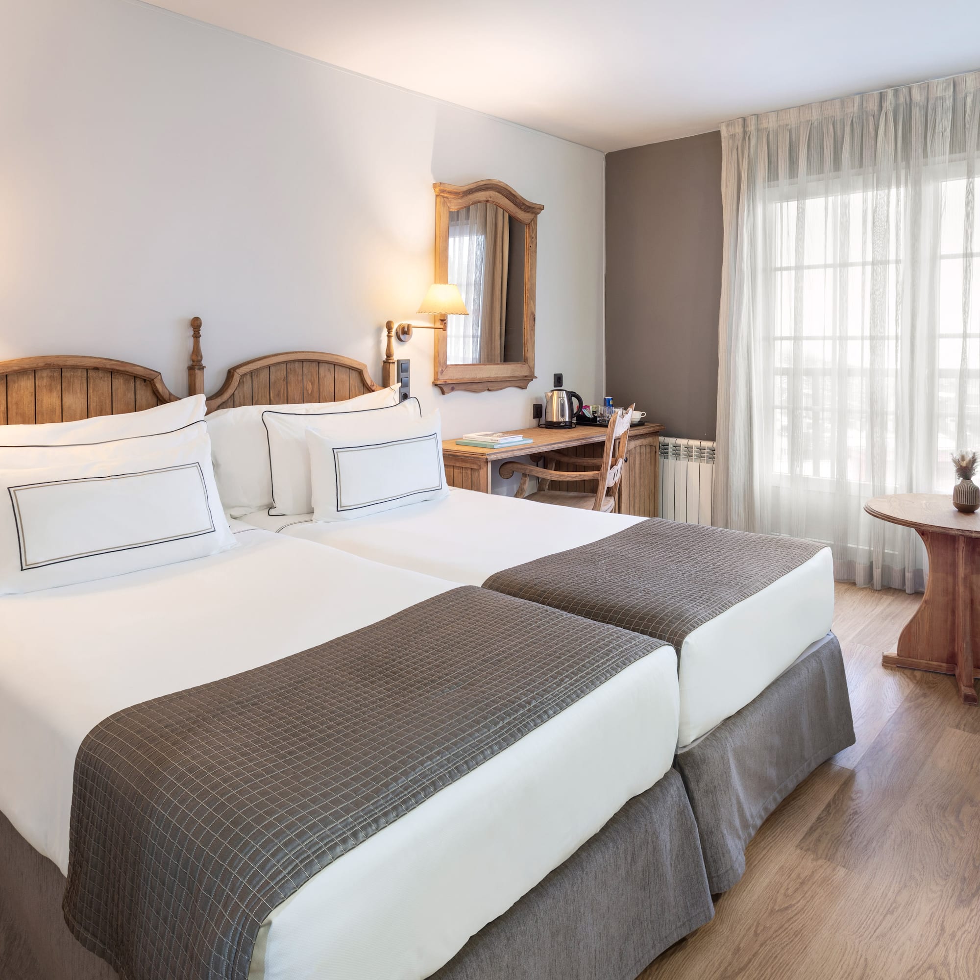 a room with two beds and a table