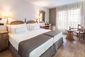 a room with two beds and a table