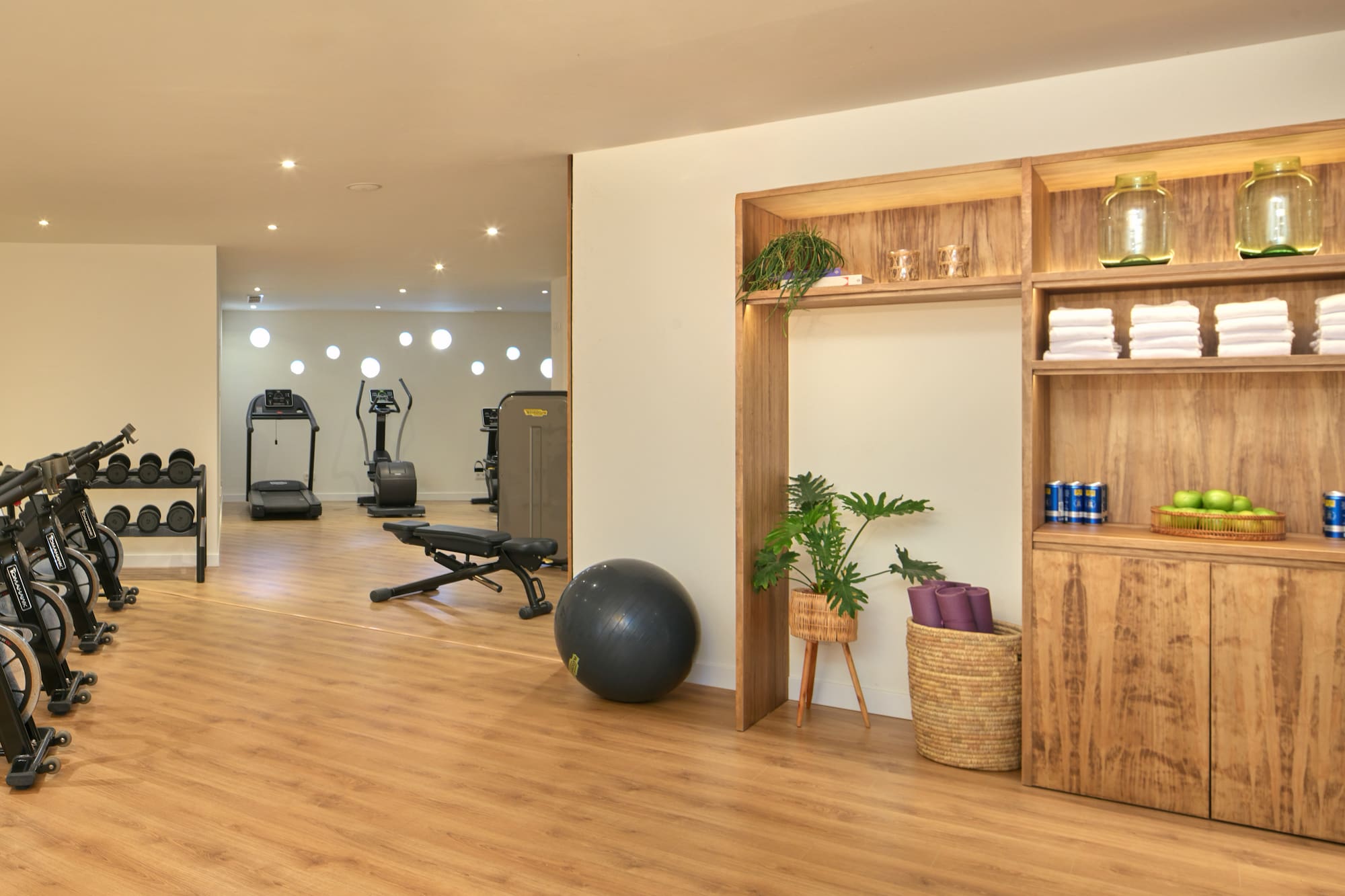 a room with exercise equipment and a shelf