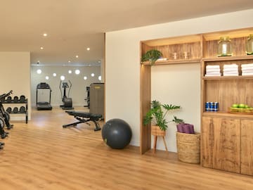 a room with exercise equipment and a shelf