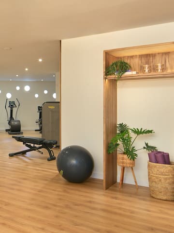 a room with exercise equipment and a shelf