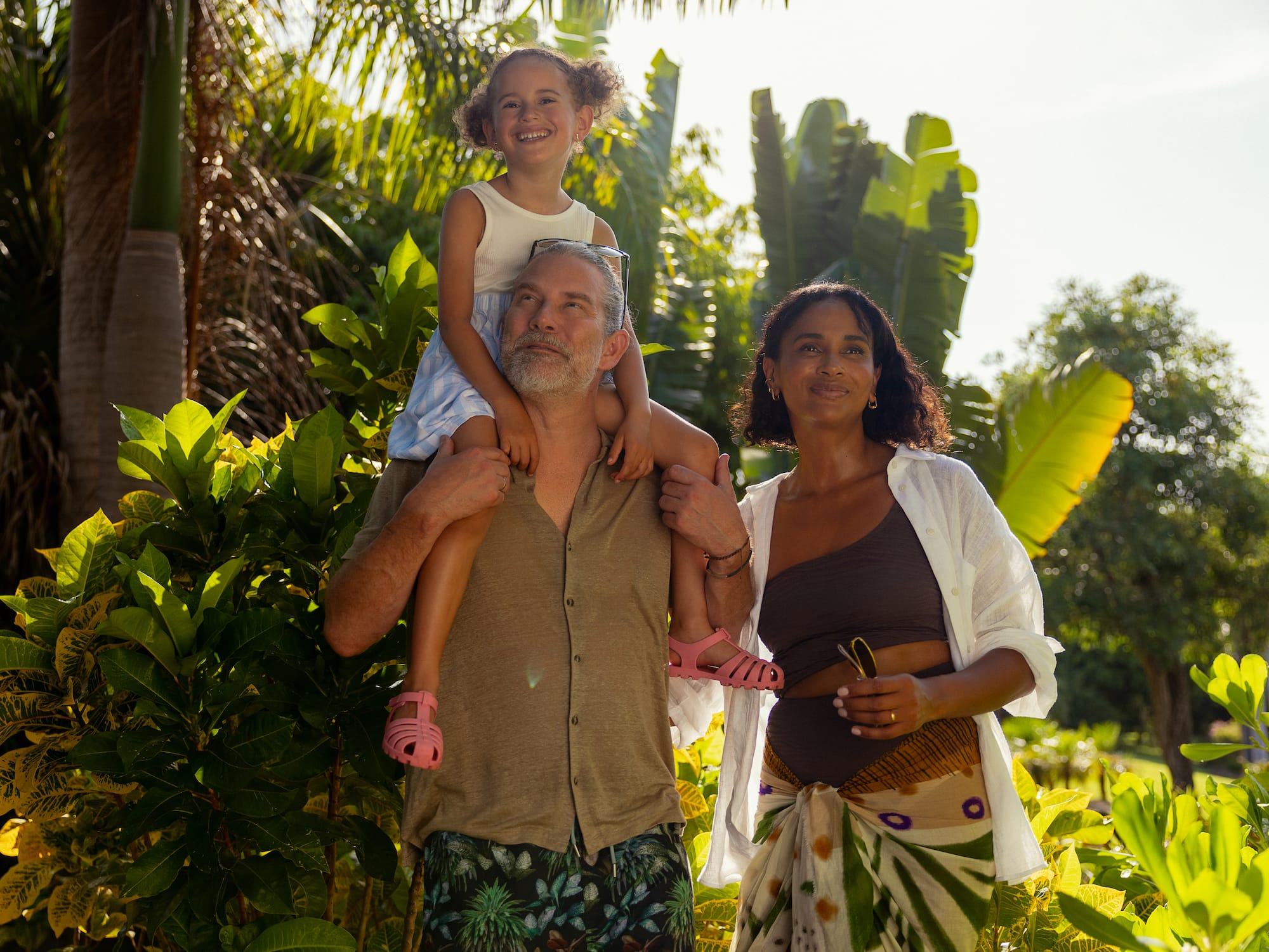 a man and woman with a girl on his shoulders