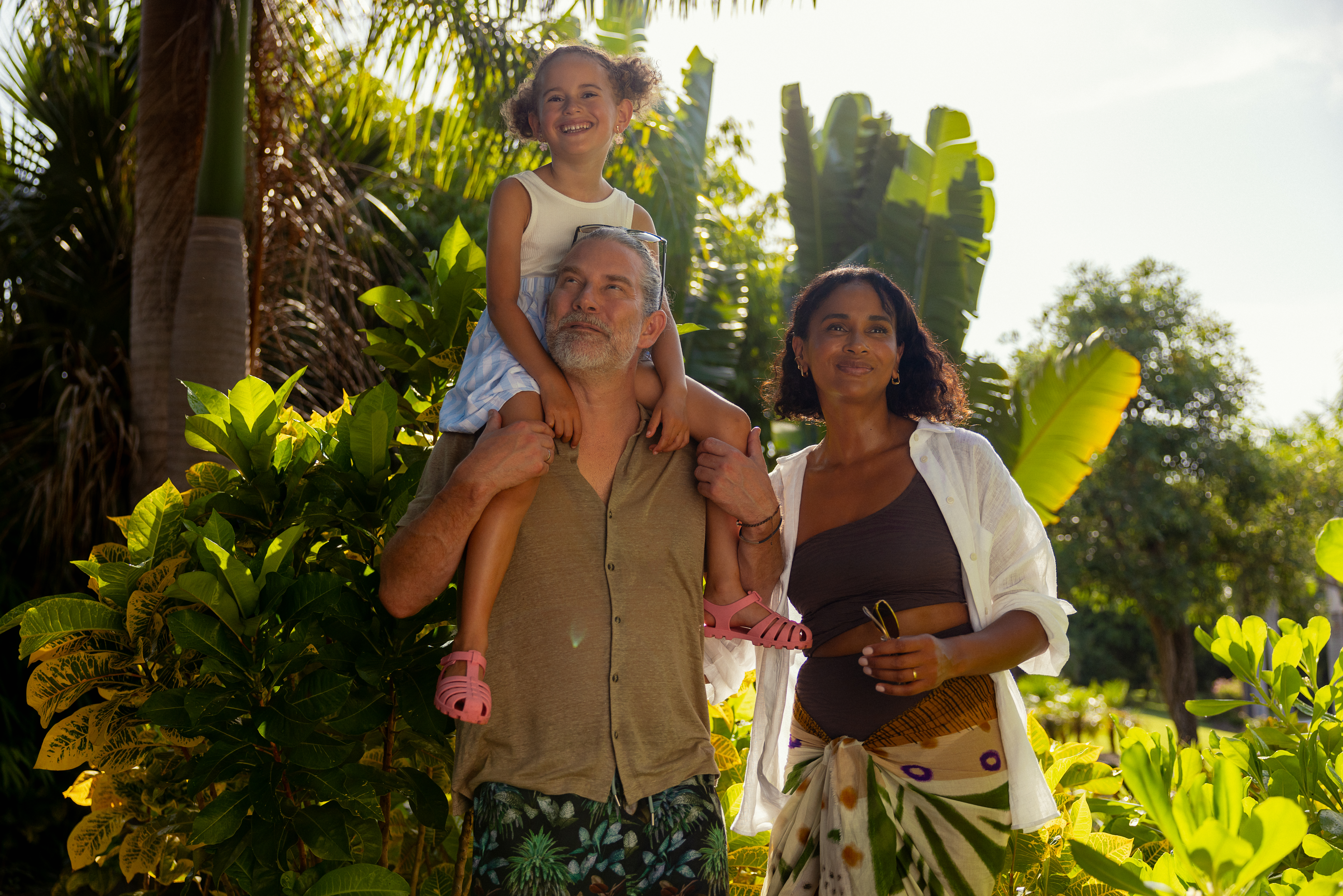a man and woman with a girl on his shoulders