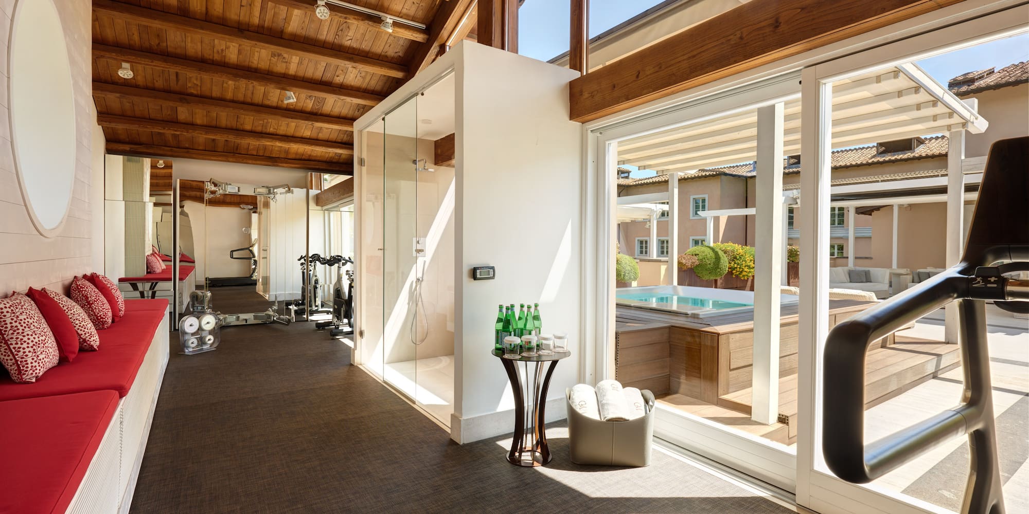 a room with a gym and a pool