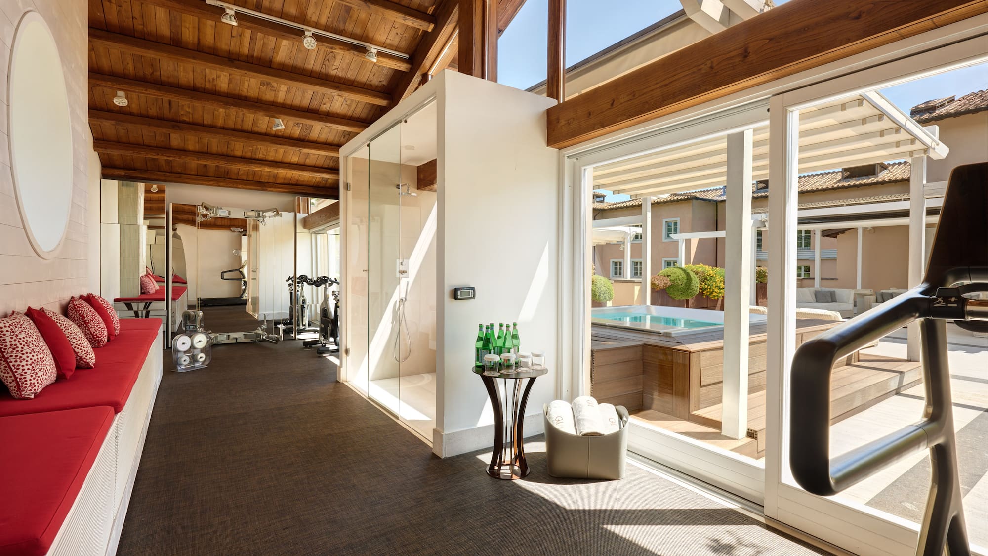 a room with a gym and a pool