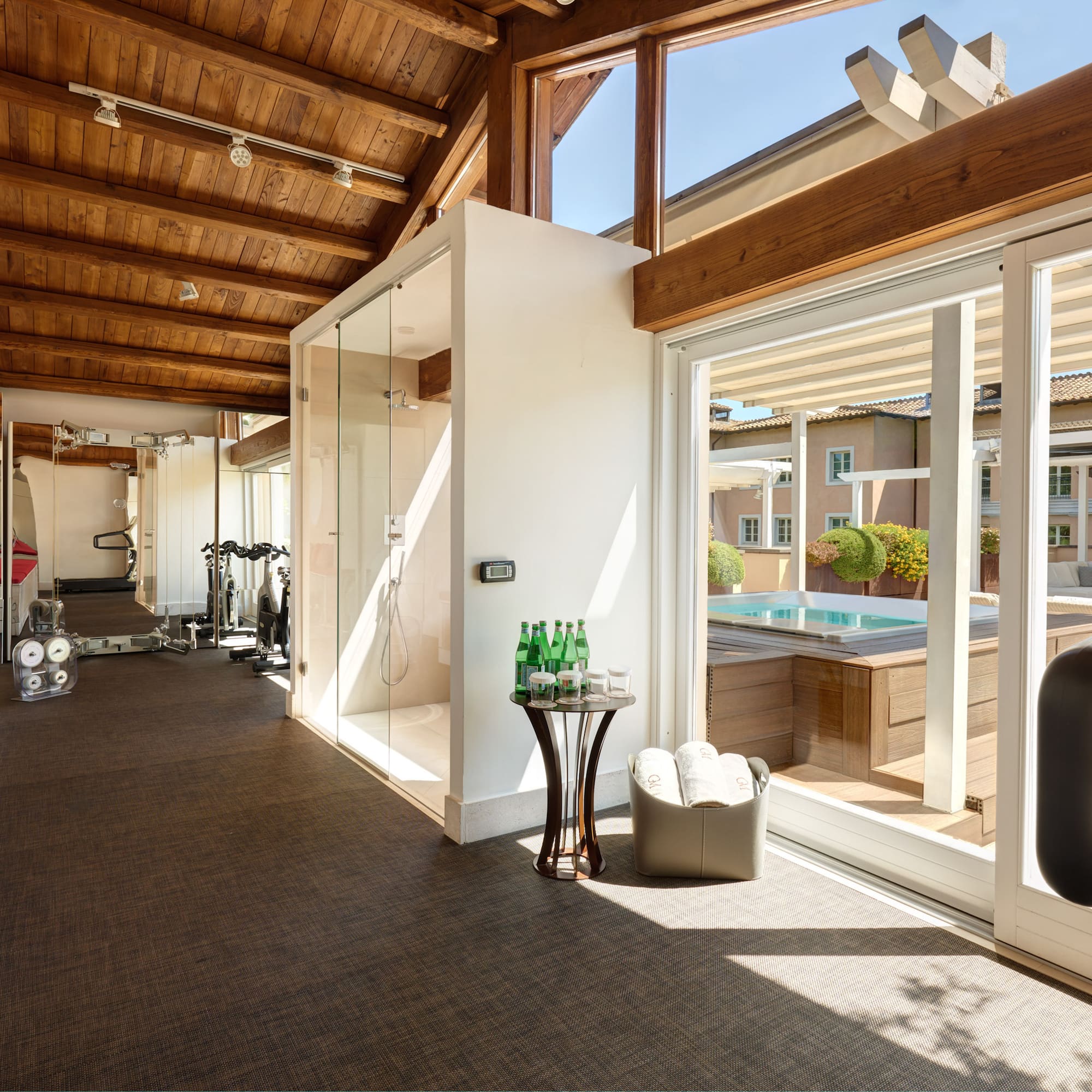 a room with a gym and a pool