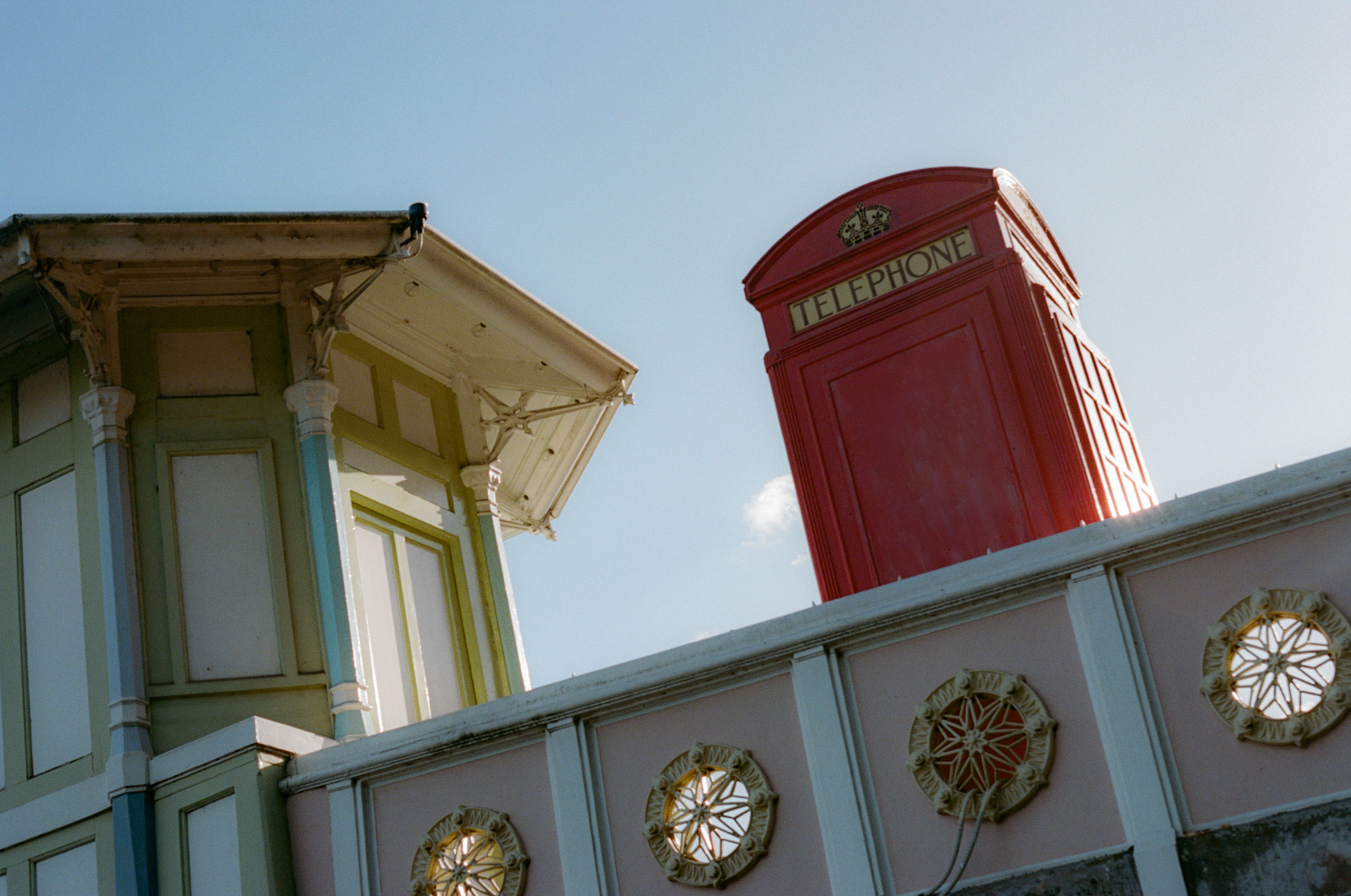 a red telephone booth on a wall