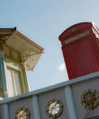 a red telephone booth on a wall