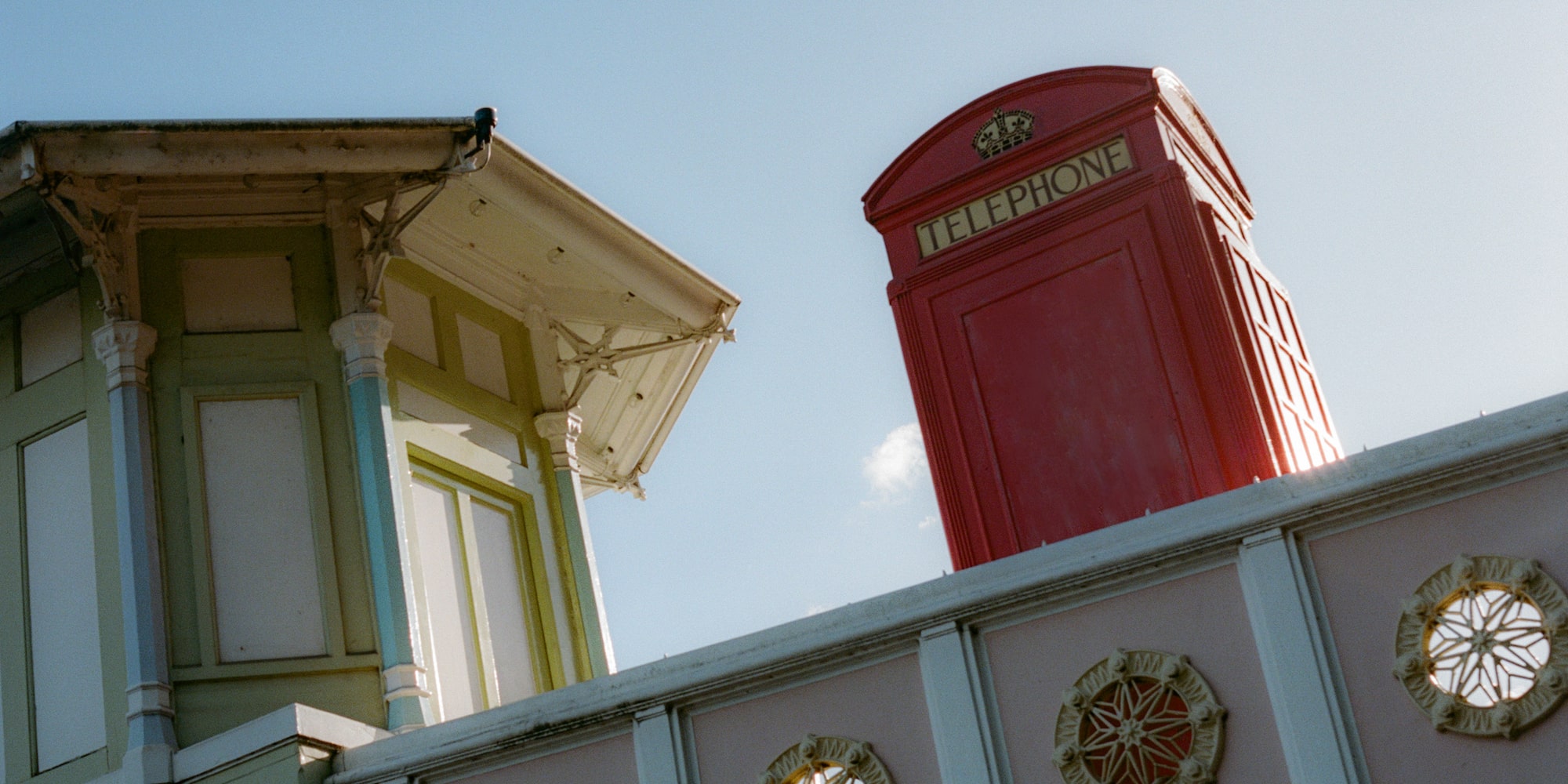 a red telephone booth on a wall