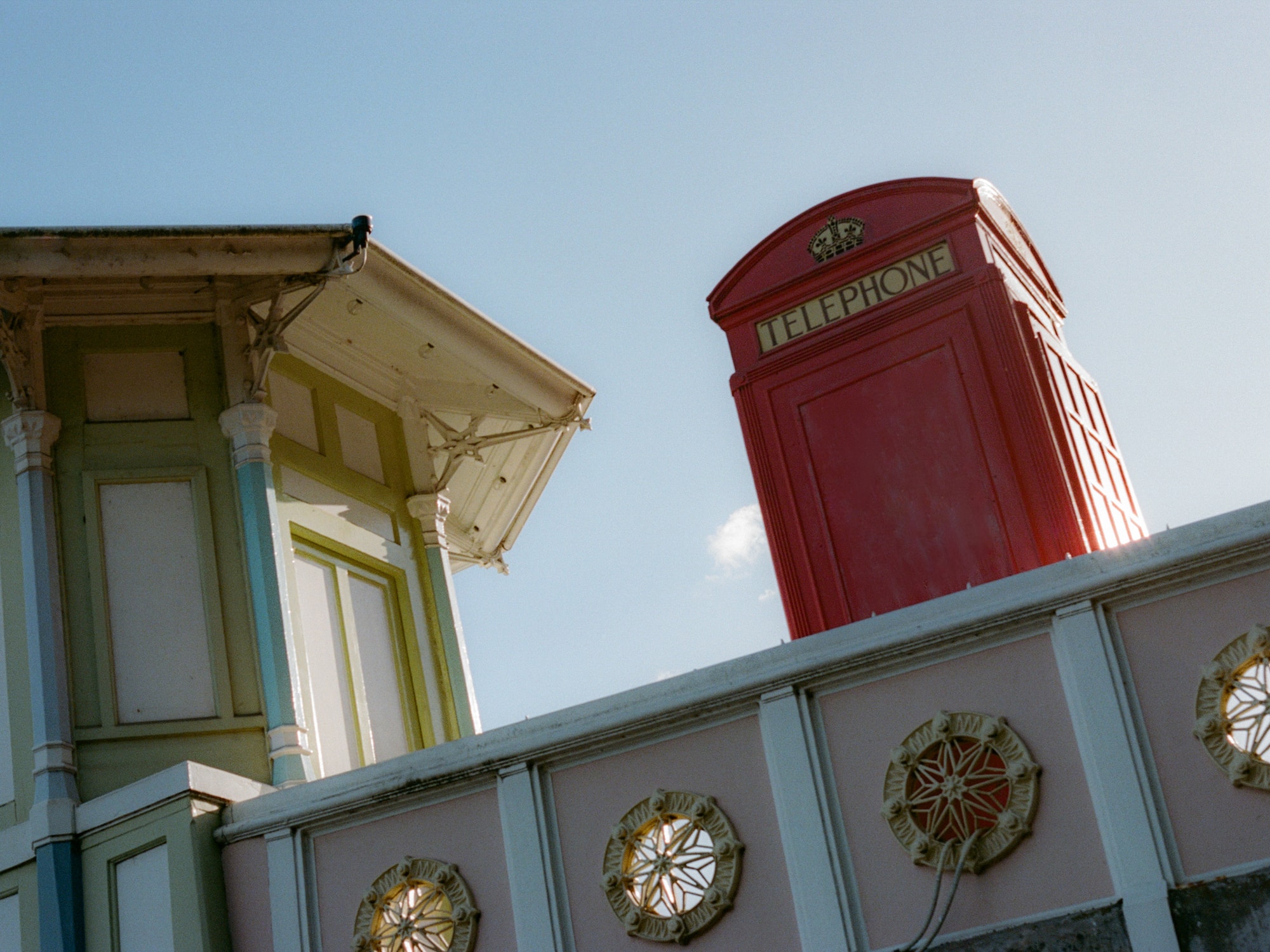 a red telephone booth on a wall