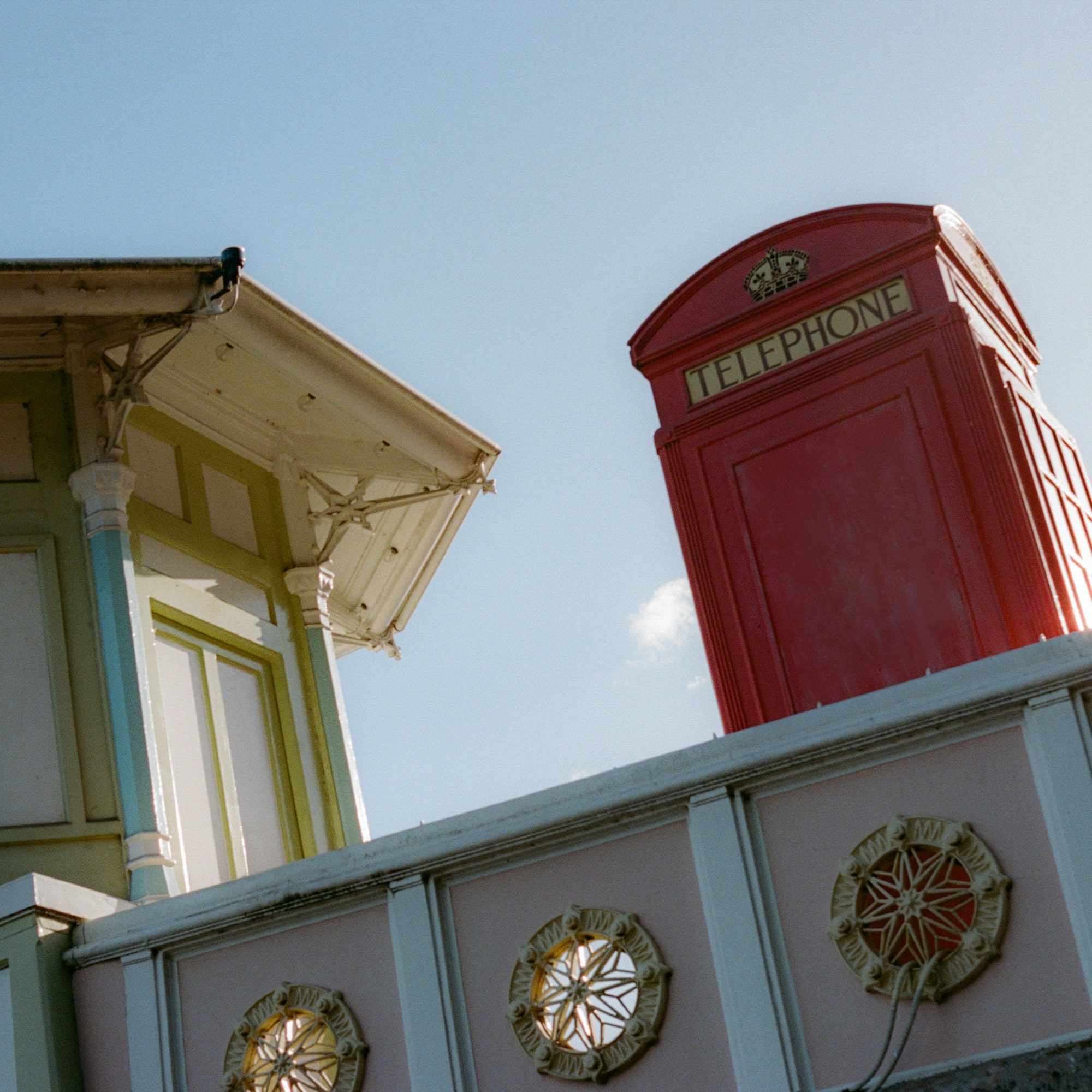 a red telephone booth on a wall