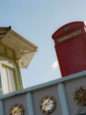 a red telephone booth on a wall