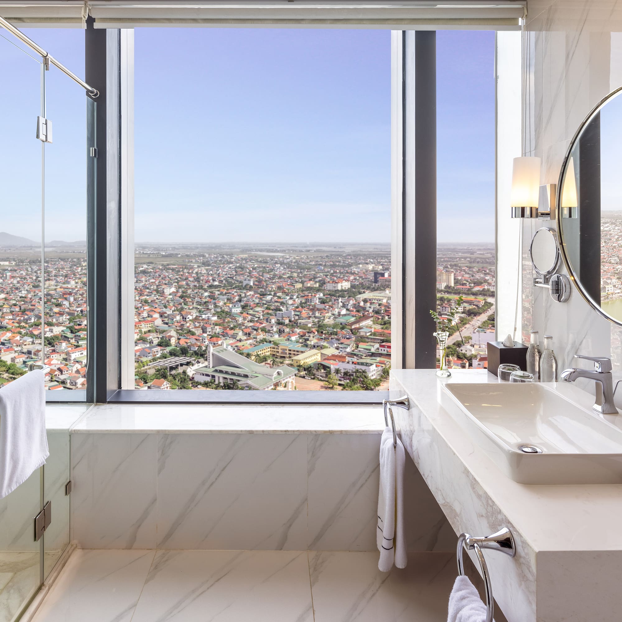 a bathroom with a large window and a large sink