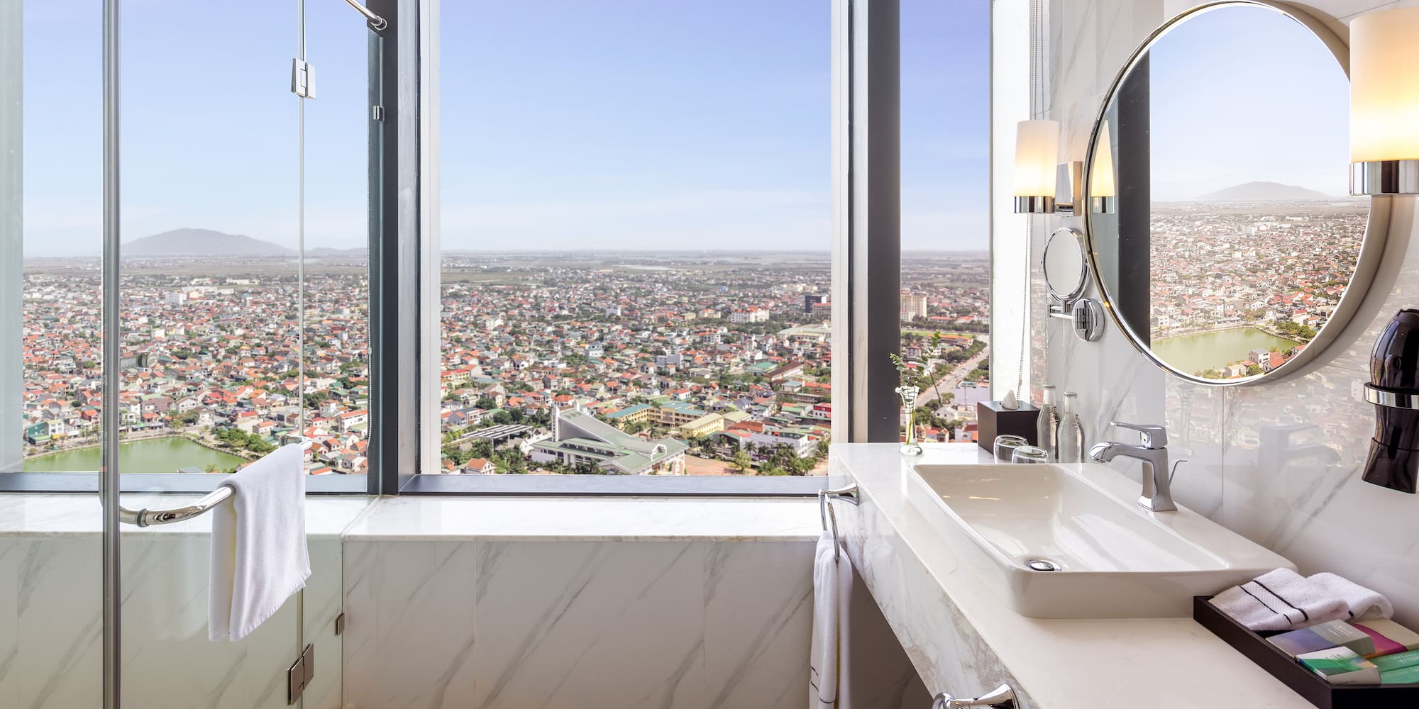 a bathroom with a large window and a large sink