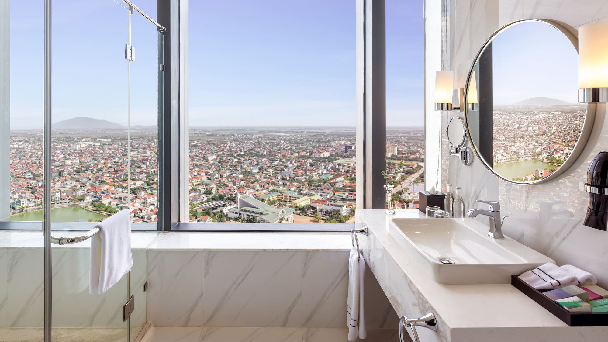 a bathroom with a large window and a large sink