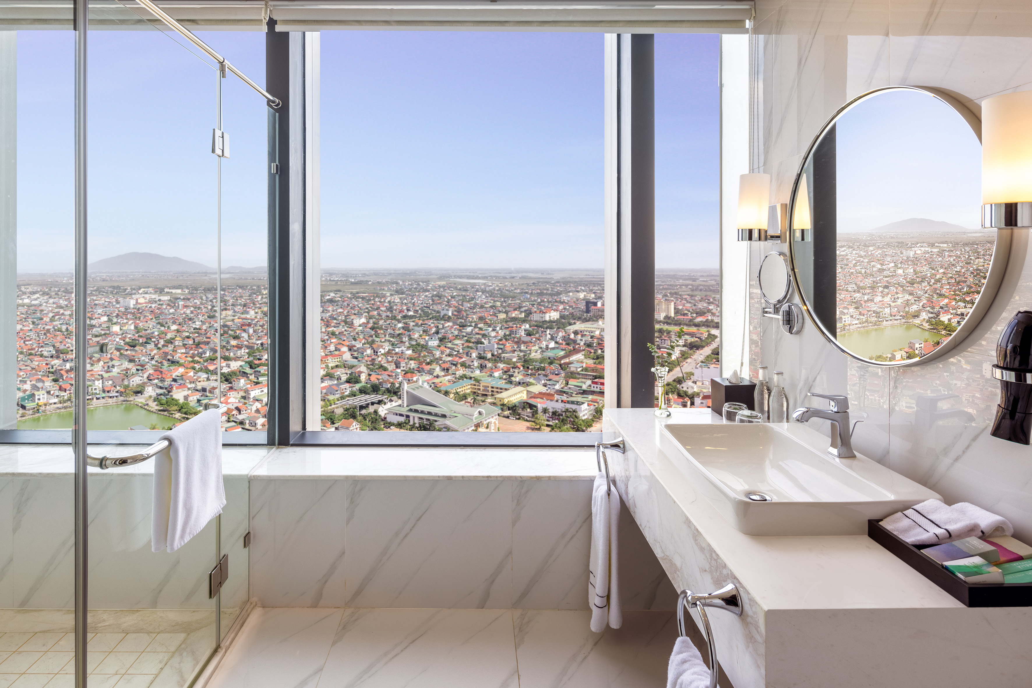 a bathroom with a large window and a large sink