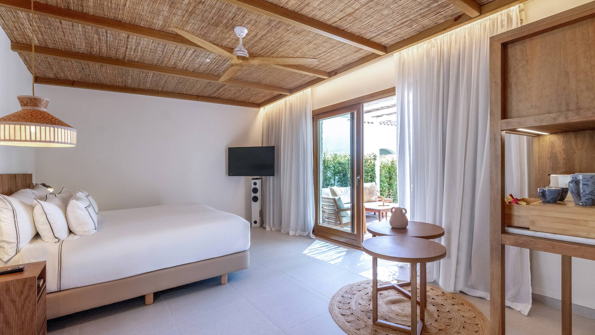 a room with a bed and a television