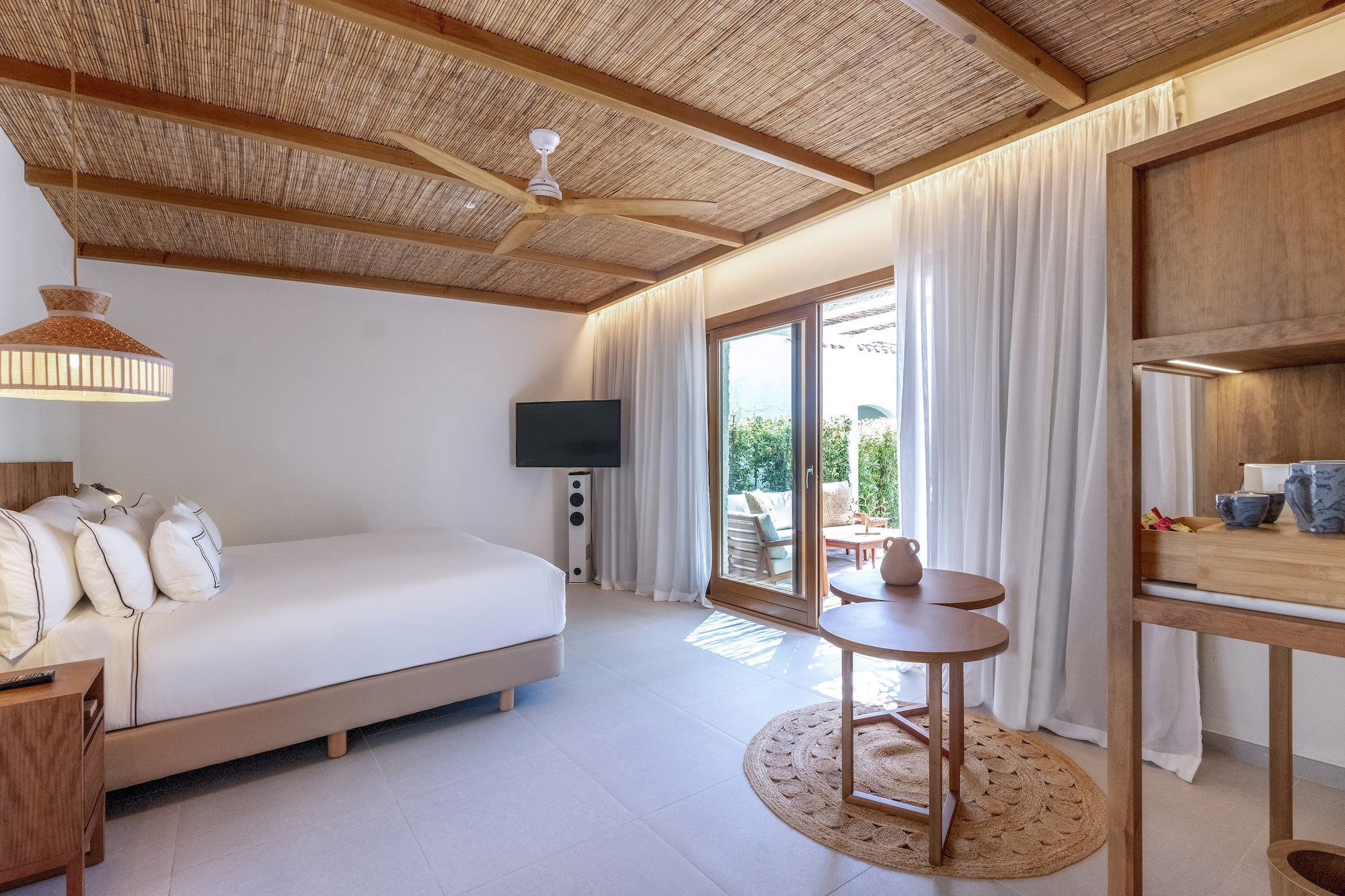 a room with a bed and a television