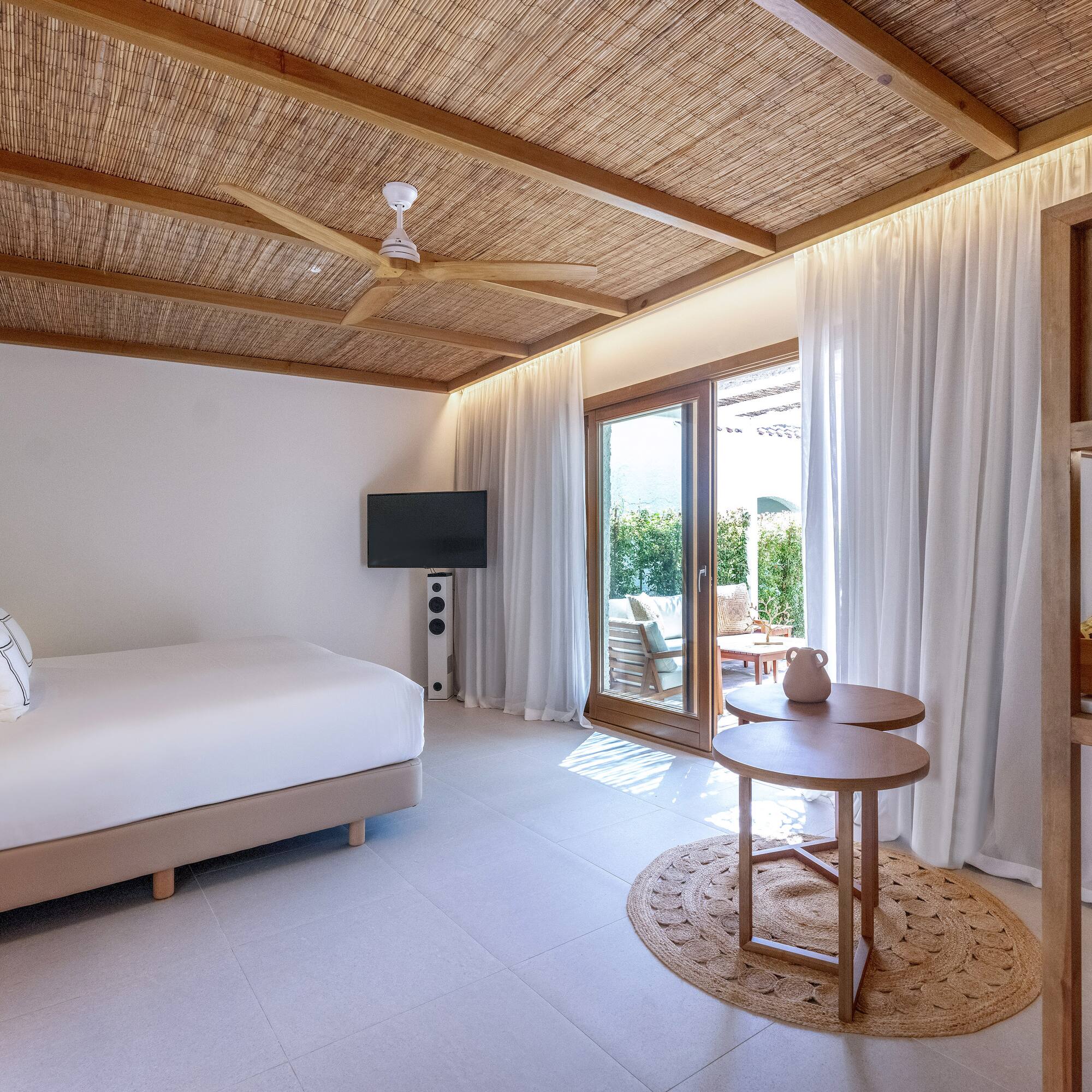 a room with a bed and a television