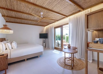 a room with a bed and a television